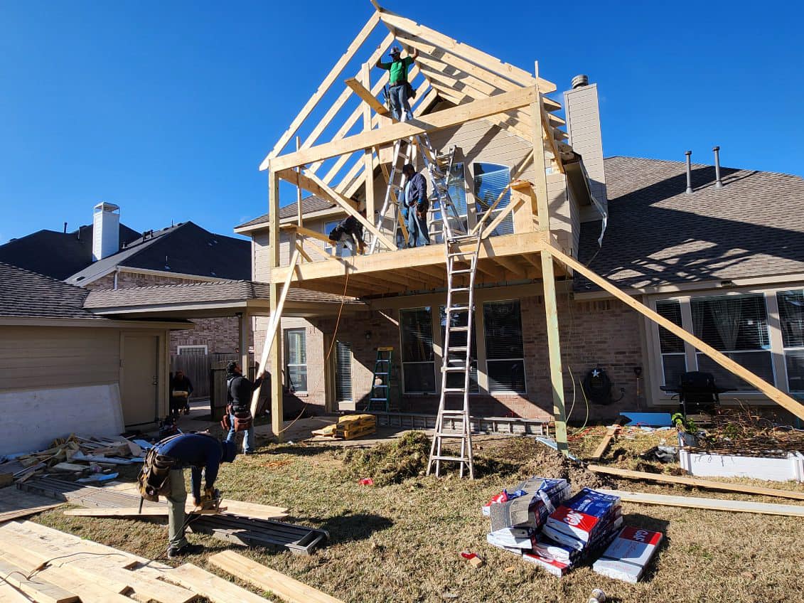 One Stop Outdoor Construction crew building a patio cover frame